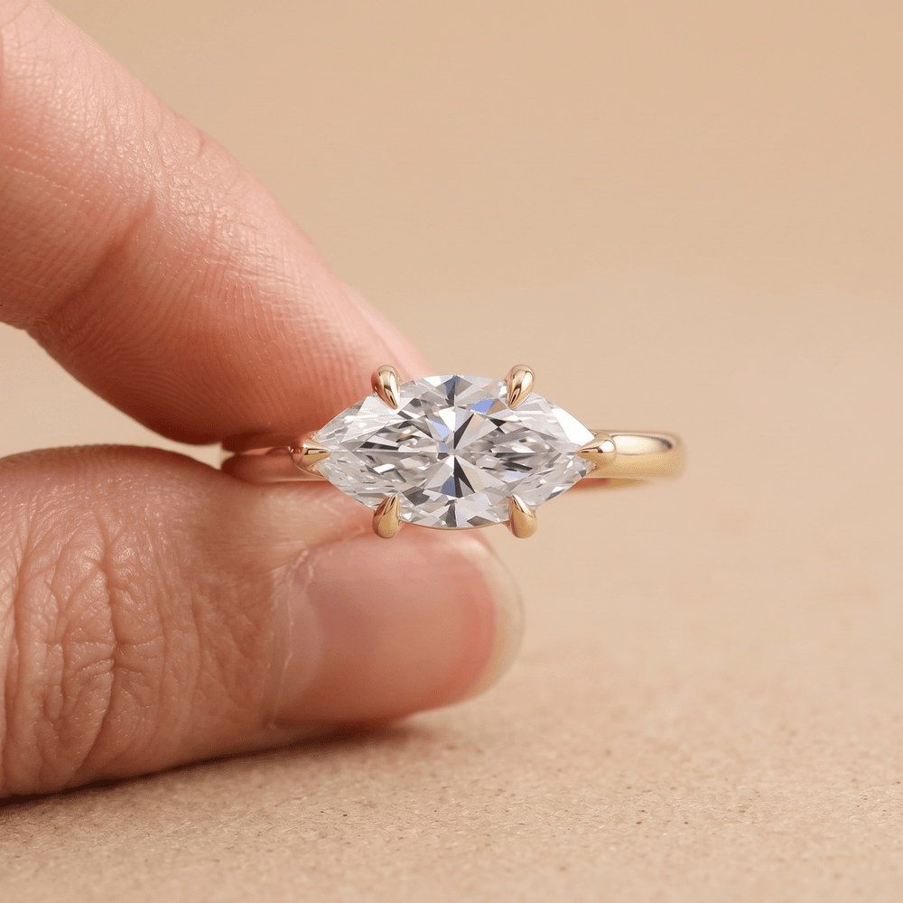 Curved 14K band East West marquise ring on hand