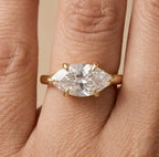 Curved 14K band East West marquise ring on hand