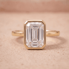 Anniversary ring with sleek bezel set emerald diamond