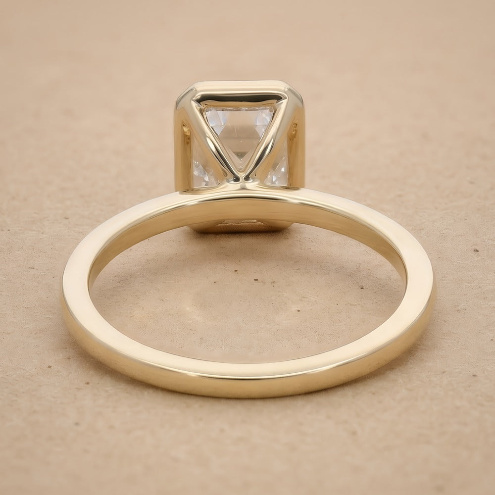 Bezel set emerald cut diamond bridal ring top view