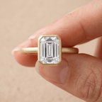 Emerald bezel set anniversary ring on hand
