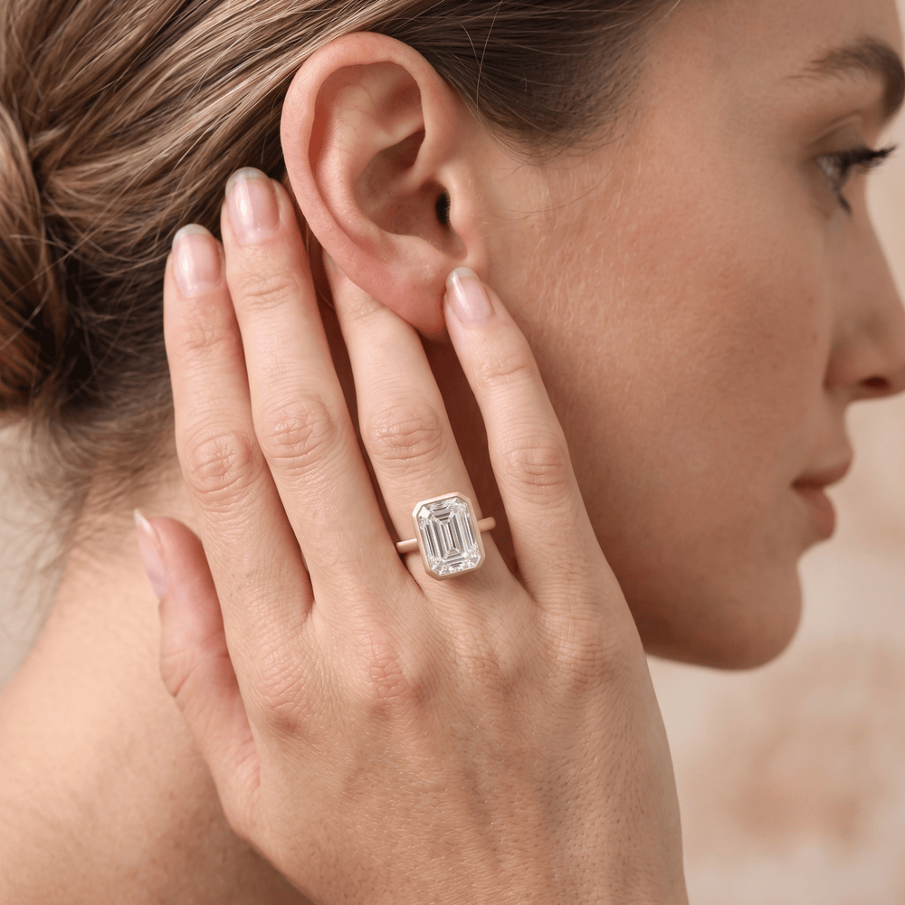 Emerald bezel set anniversary ring on hand Finger lifestyle shot