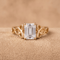 Emerald Celtic engagement ring with moissanite center stone