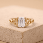 Emerald Celtic engagement ring with moissanite center stone