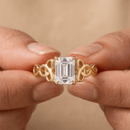 Emerald cut Celtic moissanite ring on hand model