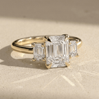 Emerald cut diamond engagement ring with a gold setting