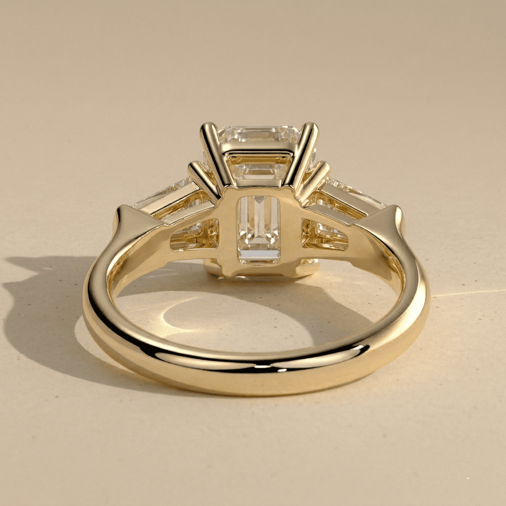 Three stone emerald lab diamond engagement ring with baguettes