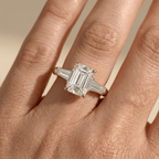 Emerald center stone engagement ring with baguette diamonds