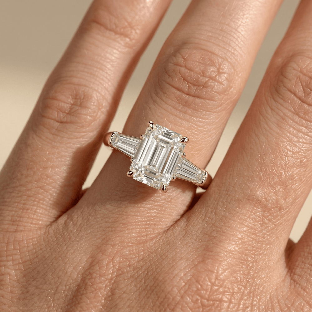Emerald center stone engagement ring with baguette diamonds
