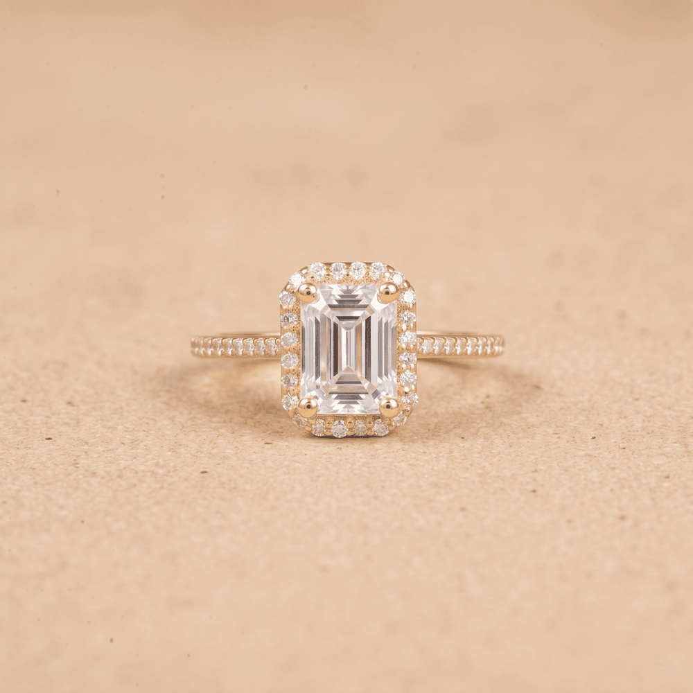Halo ring with emerald cut center stone