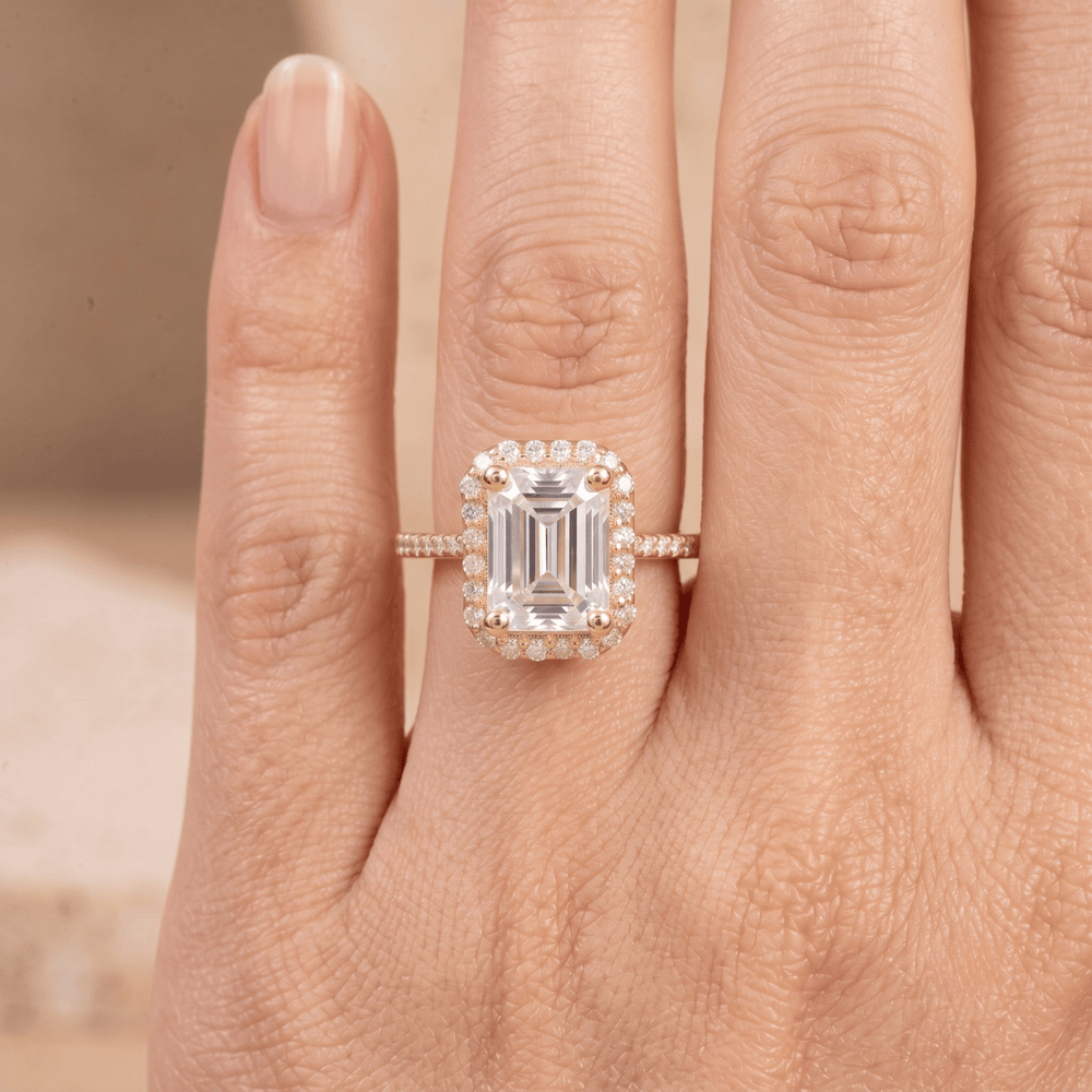Emerald cut halo ring worn on hand
