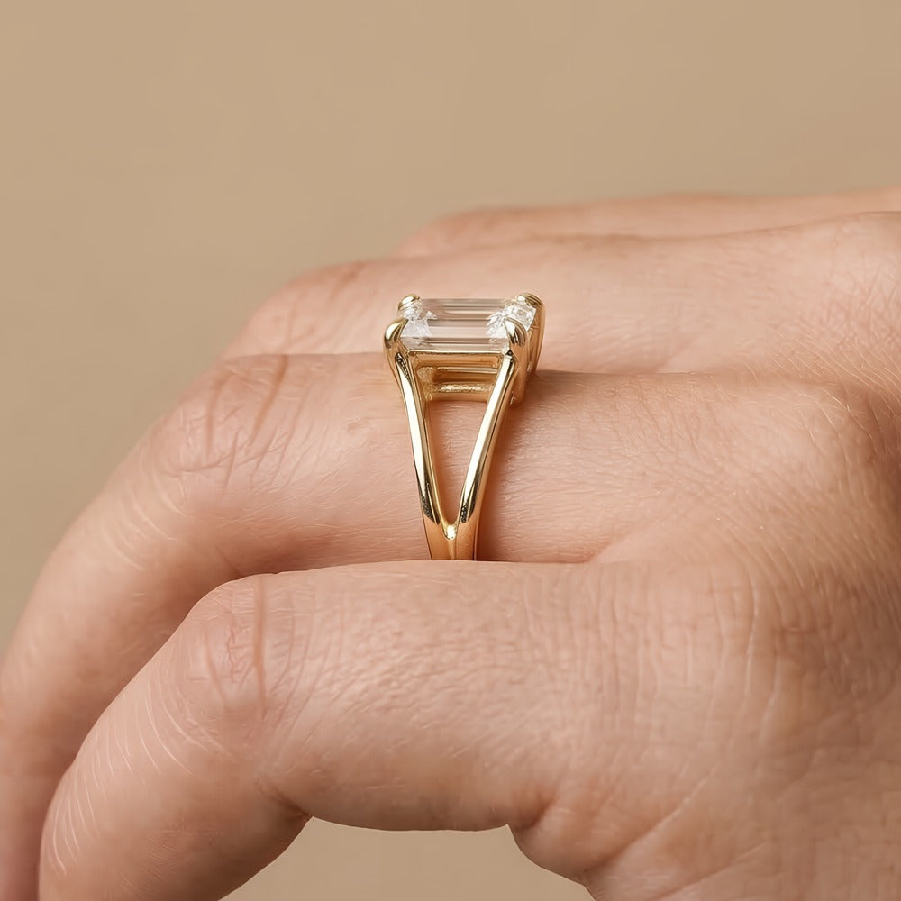 Ethically sourced emerald cut solitaire ring on ring finger