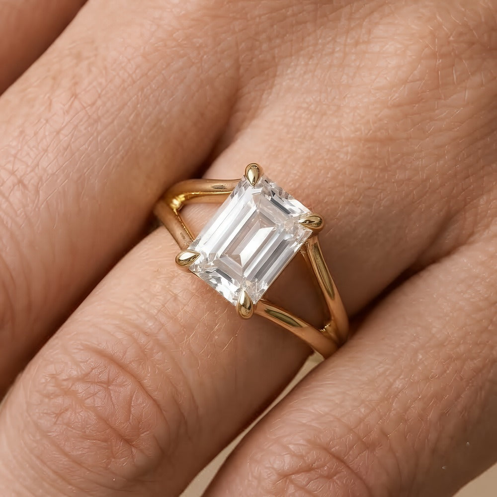 Ethically sourced emerald cut solitaire ring on ring finger