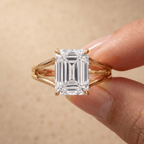 Emerald cut split shank solitaire ring on model's hand