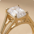 Close-up of emerald lab grown diamond in split shank setting