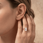 Ethically sourced emerald cut solitaire ring on ring finger
