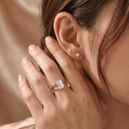 Ethically sourced emerald cut solitaire ring on ring finger