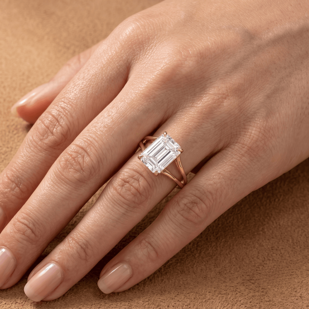 Ethically sourced emerald cut solitaire ring on ring finger