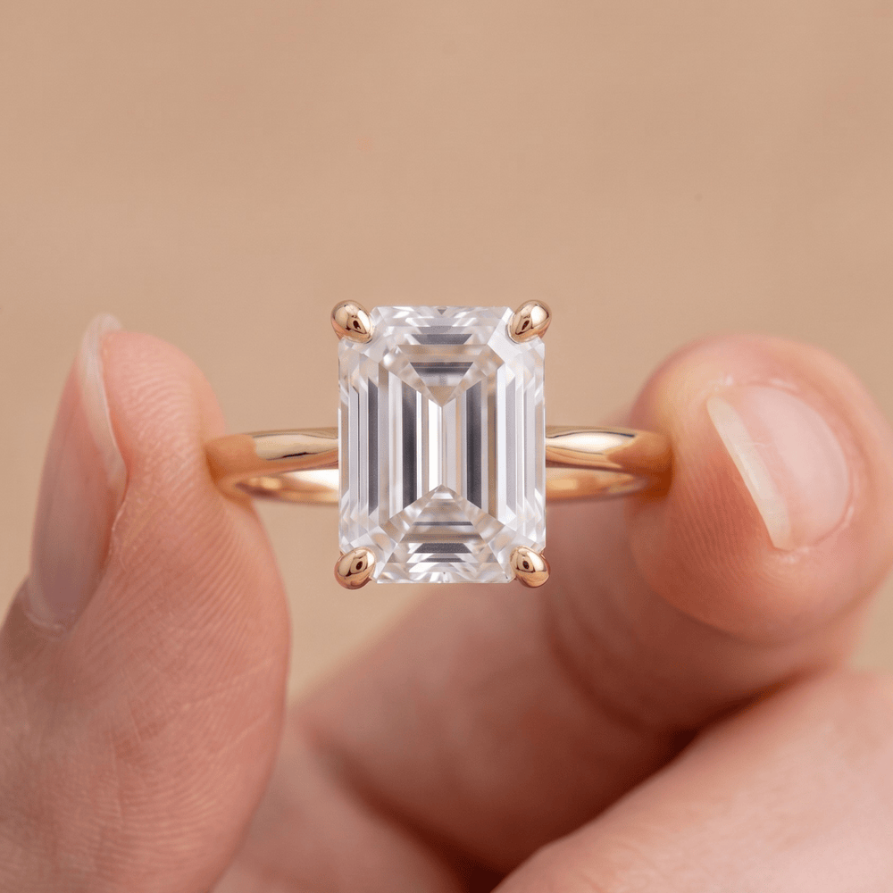 14K gold wedding ring with emerald cut moissanite