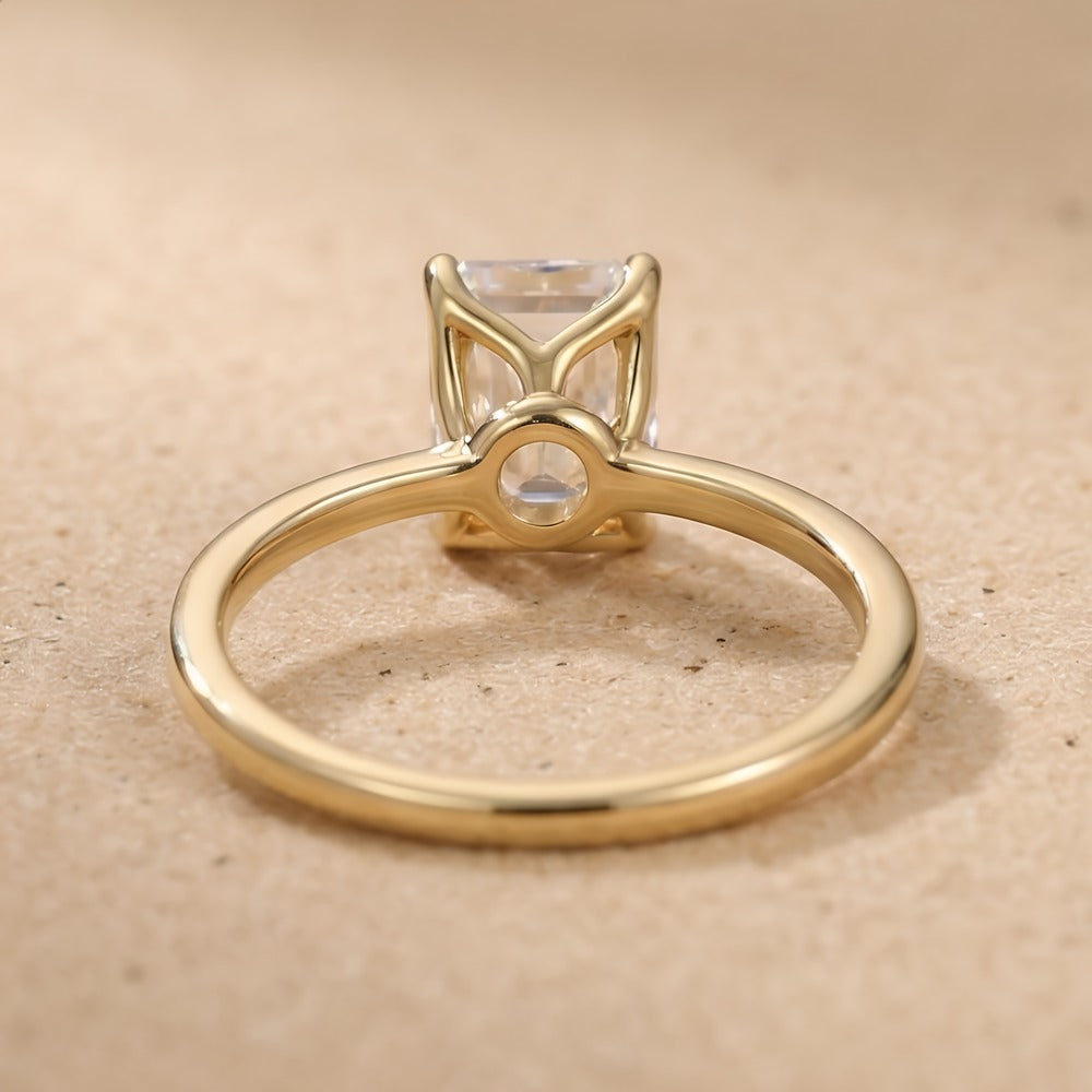 Dainty emerald moissanite ring top angle view