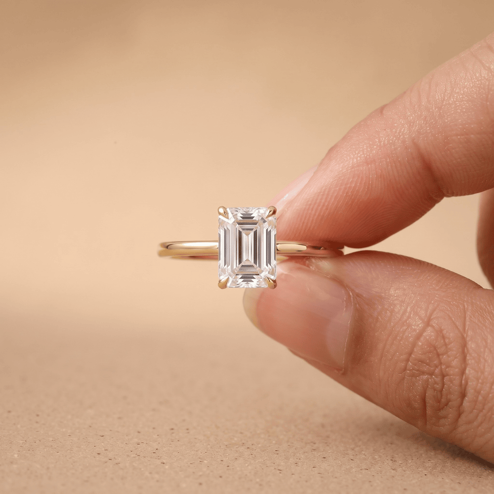 Emerald moissanite promise ring side profile on model hand