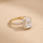 Emerald moissanite ring with diamond halo, side angle