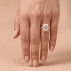 Petite emerald halo ring shown on model's hand