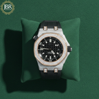 Luxury diamond-encrusted watch on a green cushion with JBR Jewels logo.