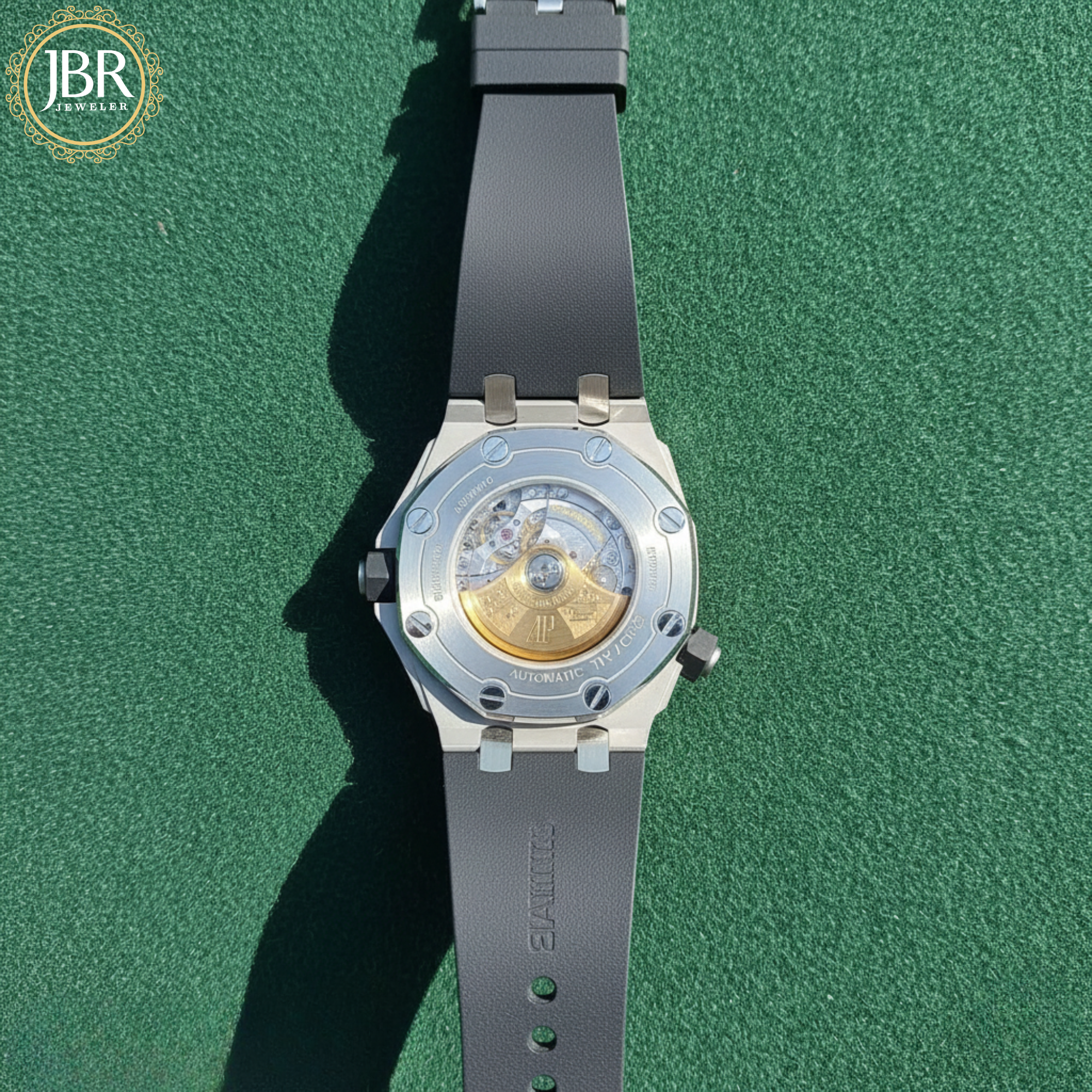 Watch with a black strap on a green background, featuring the JBR Jewels logo.
