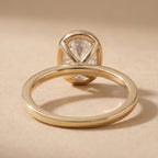 Bezel set oval diamond ring top angle view