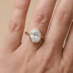 Bezel set oval diamond proposal ring on hand