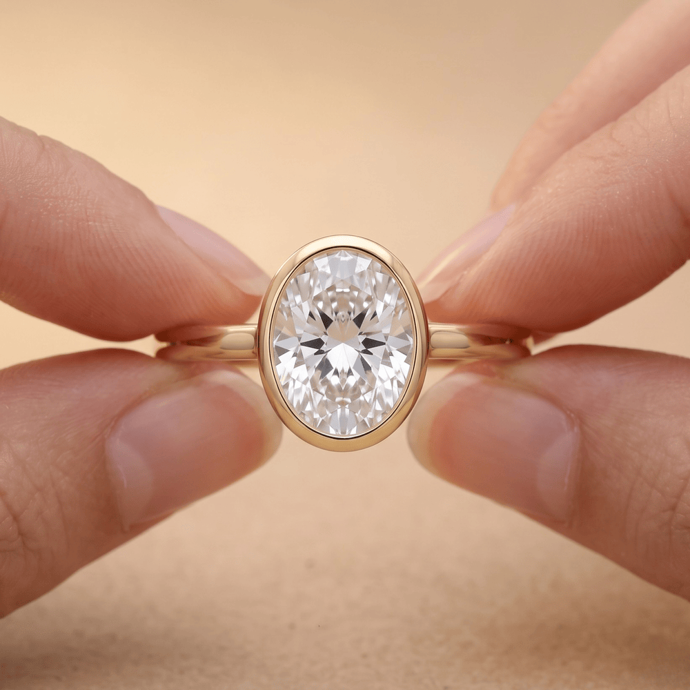 Bezel set oval diamond proposal ring on hand