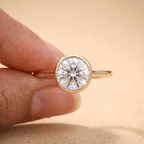 Round bezel lab diamond ring worn on hand