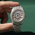 Luxury two-tone men’s wristwatch featuring a gold and silver stainless steel band, fully iced-out bezel and dial set with VVS moissanite stones, bold Roman numeral hour markers, and a high-polish finish for a flashy, high-end look.