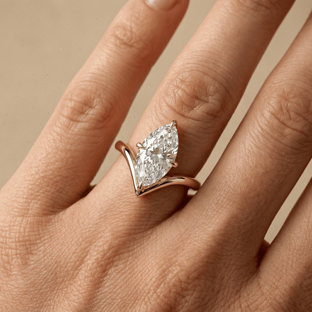 Curved gold engagement ring with marquise cut lab diamond