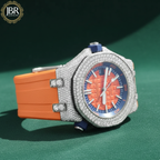 Luxury watch with orange strap and diamond-studded face on a green background, branded JBR.
