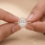 Halo oval diamond promise ring on hand