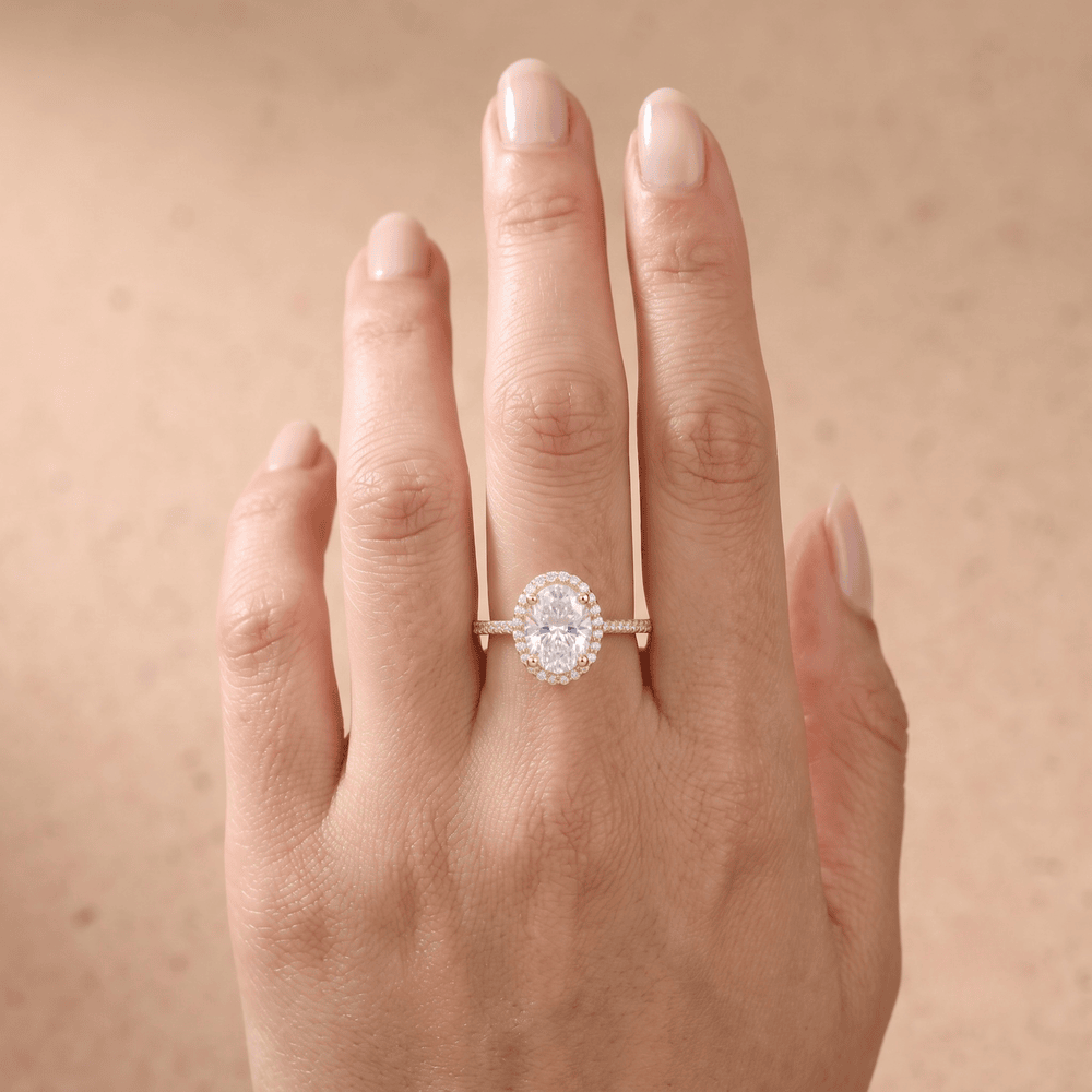 Halo oval diamond promise ring on hand