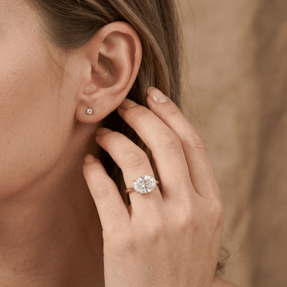 Oval solitaire ring east west lifestyle shot for bride