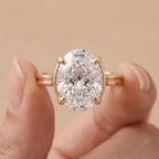 Cathedral setting oval lab grown diamond ring on hand