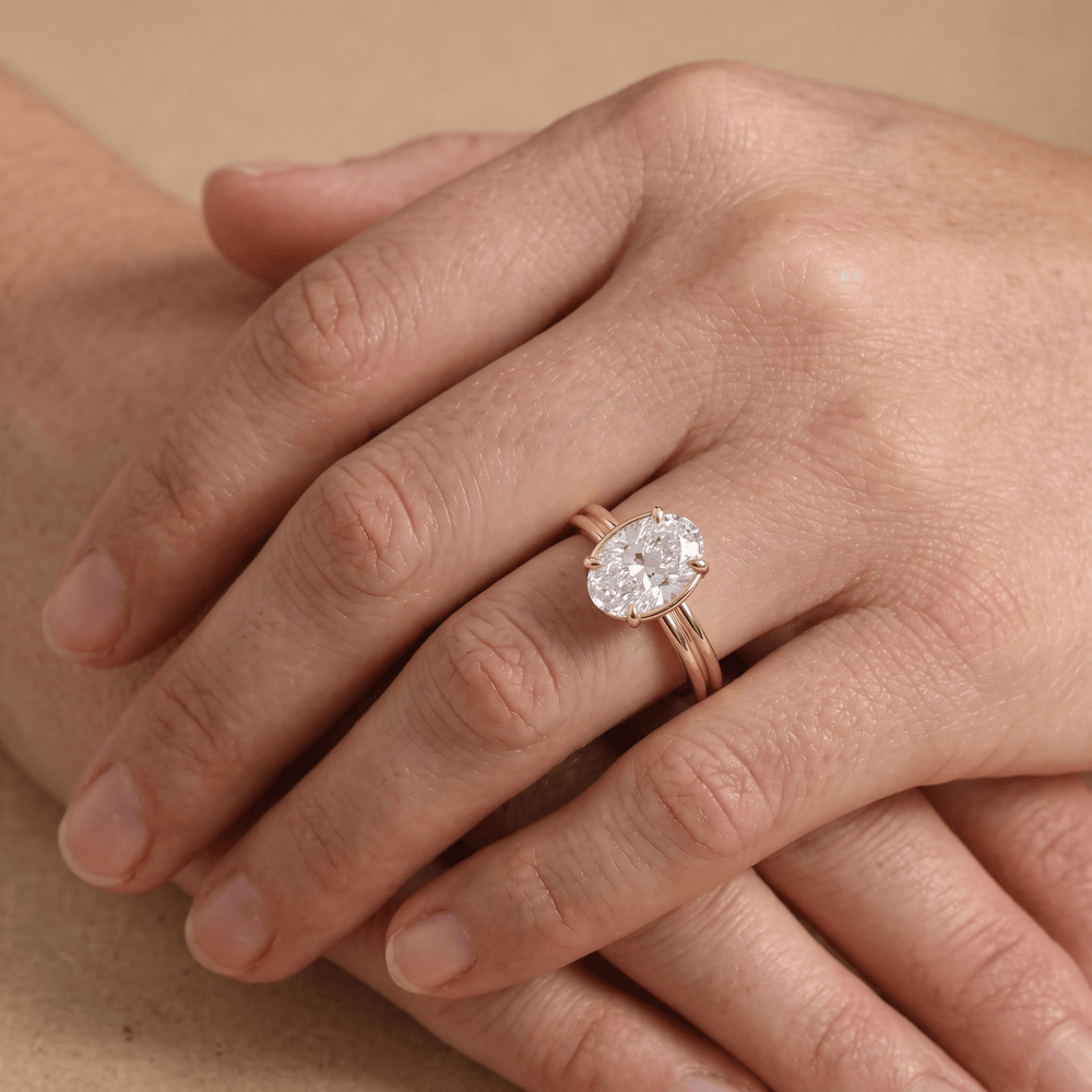 Oval lab diamond ring worn on finger, top angle