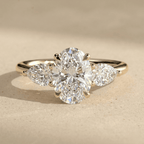 14K gold oval three stone diamond ring