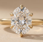 Close-up of oval cut diamond on dainty gold band