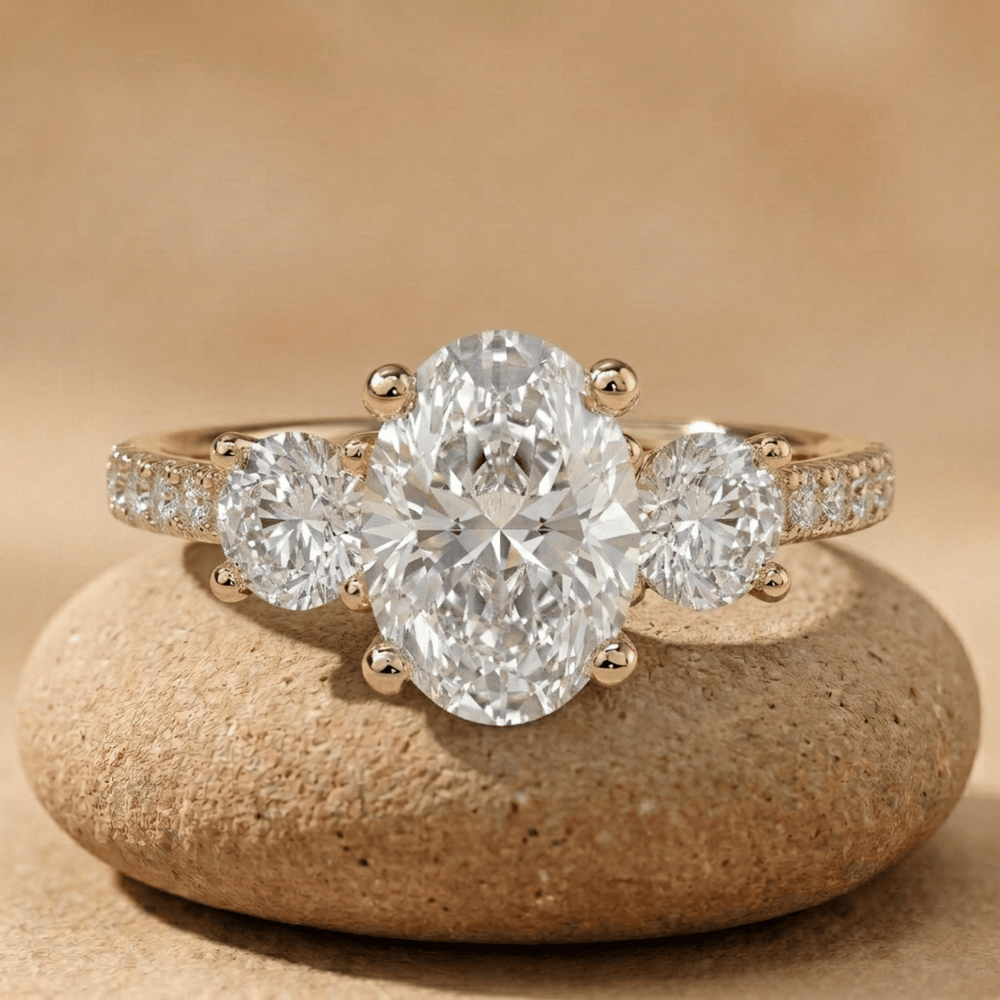 Oval lab grown three stone engagement ring with 14K pavé band