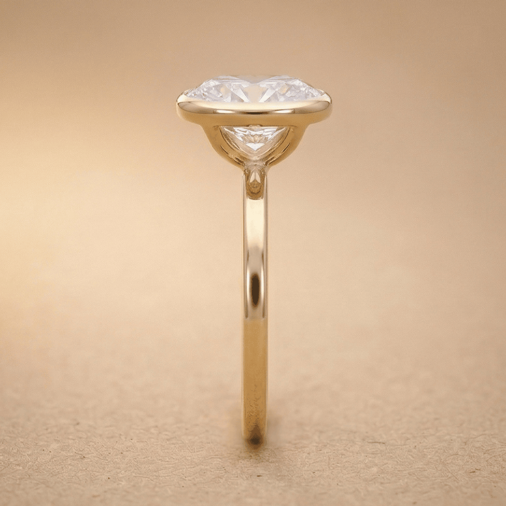 18K gold bezel set oval moissanite ring side view