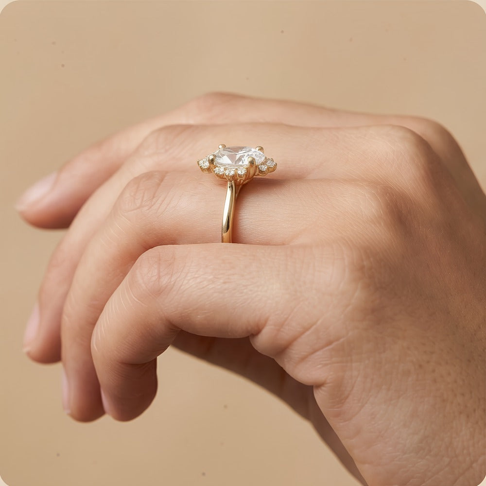 Oval cut moissanite halo ring on finger