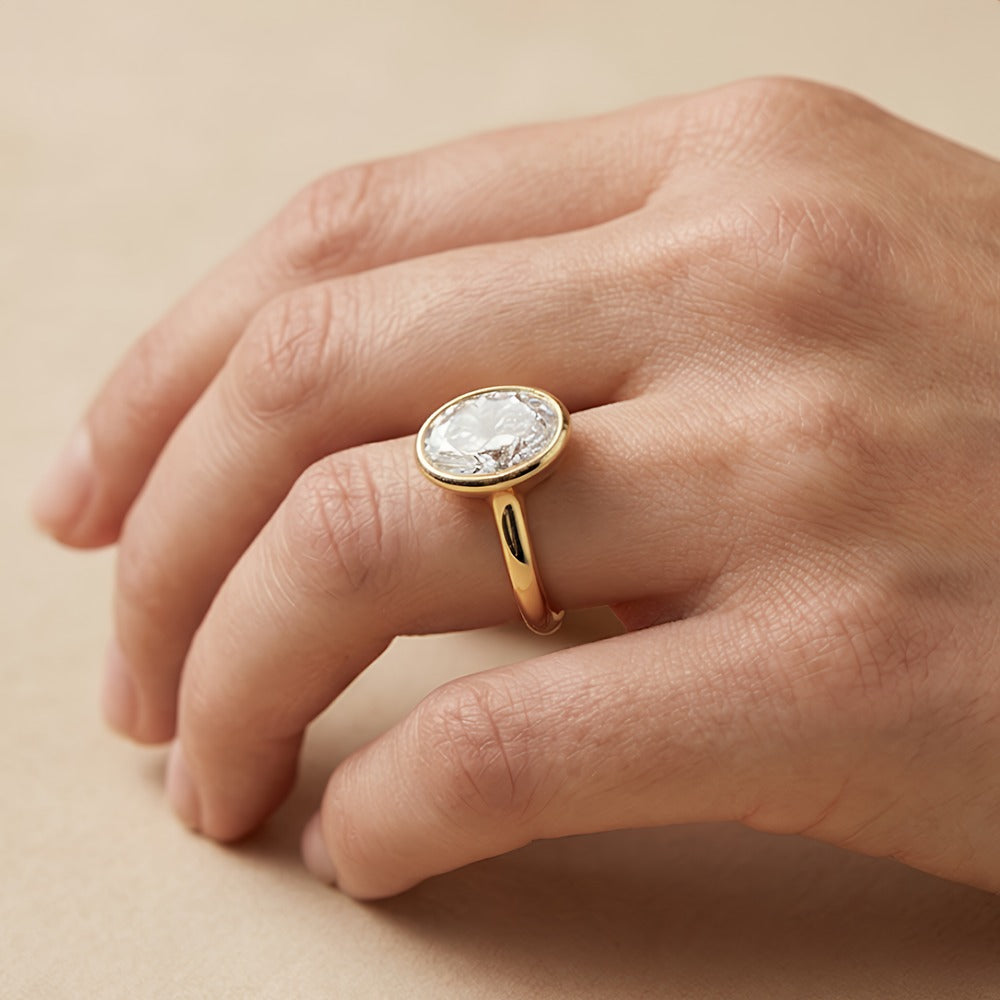 Oval moissanite ring with polished 14K bezel edge