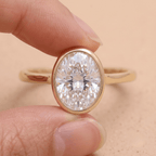 Oval cut moissanite solitaire in 14K bezel setting