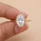 Oval cut moissanite solitaire in 14K bezel setting