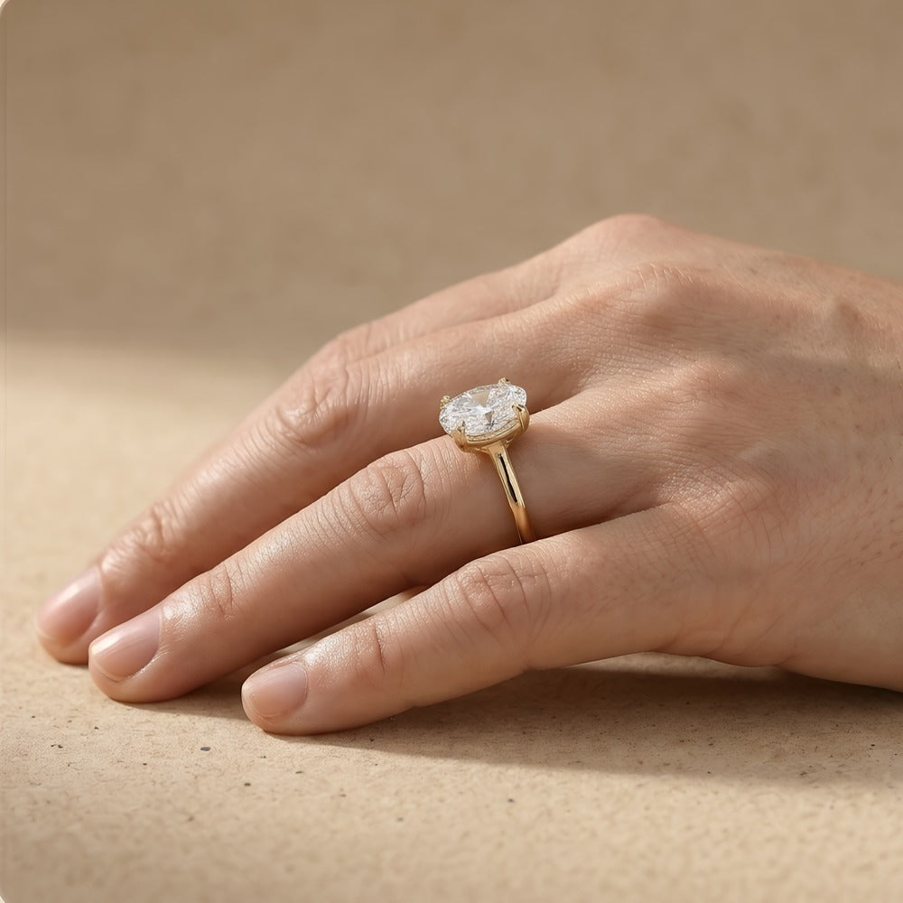 Oval moissanite celestial ring modeled on hand – 18K gold band